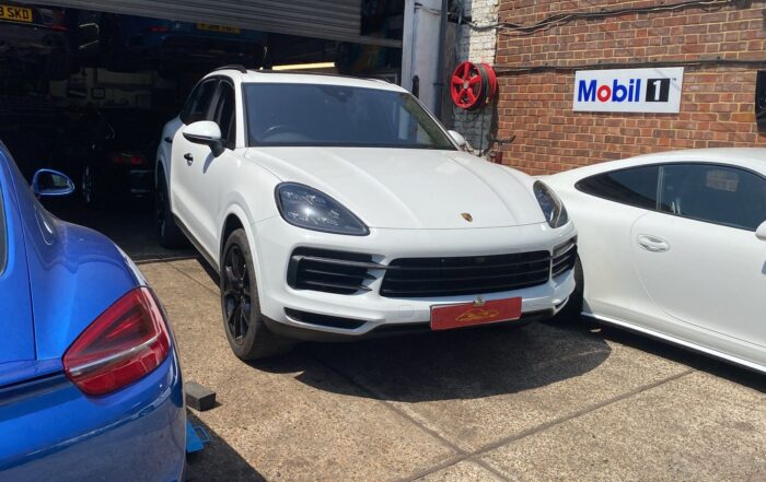 White Porsche Cayenne outside the workshop for full service and transfer box oil change